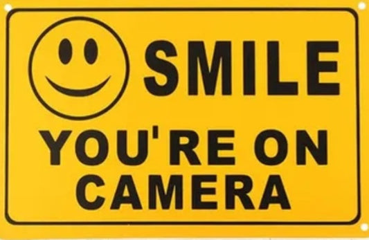 Warning smile your on camera sign